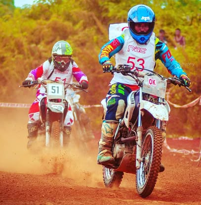 Dirt motorcycle racers on a red-earth track